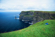 People looking out over the Cliffs of Moher, County Mayo, Republic of Ireland