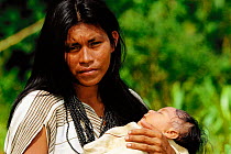 Machiguenga Indian holding baby, Timpia Community, Lower Urubamba river, Peru Amazonia