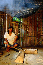 Machiguenga Indian at cooking fire, Timpia Community, Peru, Amazonia Lower Urubamba