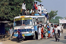 People and goods loading onto crowded bus, Rajasthan, India