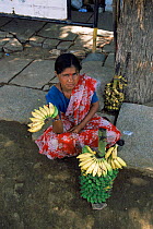 Woman selling bananas outside Virupaksha temple, India, Vijaynagar, Hampi, Karnataka, India