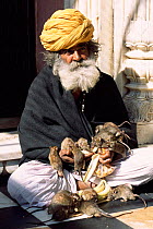 Holy man with temple rats, Karni Mata temple, Deshnoke, Bikaner, Rajasthan, India