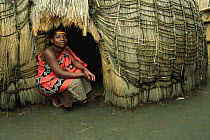 Mantenga village woman outside hut, Swaziland, Southern Africa 2001