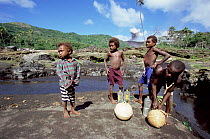 Local boys collecting water, Mountt Yasur erupting in background, Tanna, Vanuatu, South Pacific