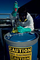 Research worker field testing toxic waste, Arizona, USA.