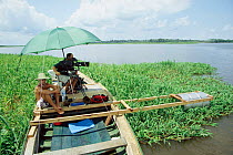 Cameraman Martyn Colbeck filming Boto river dolphins for BBC Planet Earth series, Mamirowa reserve, Brazil 2004