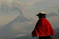 Salasacan indian with Tungurahua volcano smoking in background, Andes, Ecuador