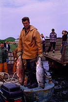 Fishermen with salmon catch, Zhupanova river, Kamchatka peninsula, Russia