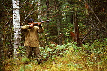 Udege hunter shooting in woodland, Primorskiy, Siberia, Russia (Ussuriland).