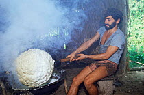 Smoking latex of Rubber tree and extracting rubber ball, Acre, Brazil