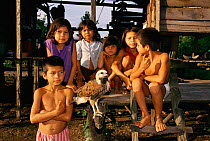 Children with pet Black collared hawk, Mamiraua Ecol Stn, Amazonas, Brazil