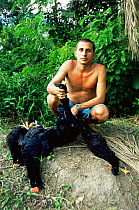 Hunter with Amazonian razor billed curassow birds {Crax mitu} Piagacu Purus Res, Brazil,