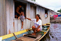 Canoe transport during flood, Jaraua village, Mamiraua Ecological Station, Amazonas, Brazil