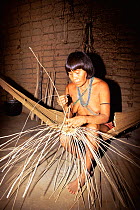 Yanomami indian woman weaving basket, Maturaca village, Amazonas, Brazil