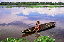 Boy in canoe, Mamiraua Ecol. Stn, flooded rainforest, Amazonas, Brazil