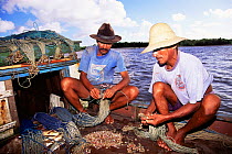 Fishermen prepare paternoster line for fishing, Canelas Is, Para, N Brazil