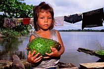 Girl with Graviola fruit {Anona muricata} Mamiraua Ecol. Stn, Amazonas, Brazil