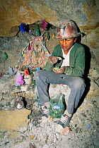 Boy in silver mine makes offering to the Devil, Cerro Rico Potosi, Bolivia