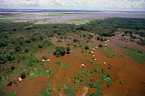 Aerial view of flooded forest and people's houses, Varzea, Amazonas river, Brazil. 1993