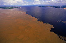 Meeting of waters of the River Solimoes and darker River Negro, Amazonas, Brazil. Rio