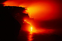 Pahoehoe lava flows off Lae' apuki bench into sea, Kilauea volcano, Hawaii, USA. Jan 2000