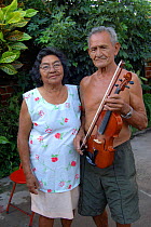 Old man with violin and his wife, Alter do Chao, Brazil.