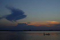 Fishermen on Arapiuns river at sunset, Para state, Brazil.