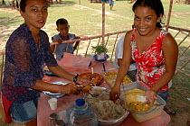 Local people enjoying Pirarucu {Arapaima gigas} meat. Para State, Brazil.