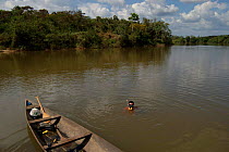Boat and diver in Pancada grande river, Para State, Brazil