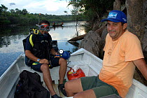 Making of BBC NHU series 'Amazon Abyss' - Diver on boat in Cachoeria do Arua river, Para, Brazil.