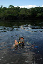 Diver in water of Cachoeria do Arua river for making of BBC NHU series 'Amazon Abyss', Para, Brazil.