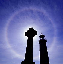Halo around the sun with gravestones + lighthouse in the foreground, Lundy Island, UK.
