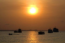 Boats on the Tapajos River at sunrise. Santarem, Brazil.