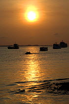 Boats on the Tapajos River at sunrise. Santarem, Brazil.