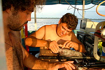 Fish experts Leandro Sousa + Mario Pinna attching fish to ROV. Brazil