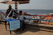Ticket sellers for boat journeys on the Amazonas river, Brazil.