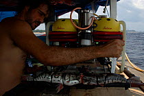 Leandro Sousa attaching fish to the front of the ROV as bait. Brazil.