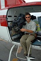 Cameraman Mike Pitts getting ready for aerial filming. Brazil.