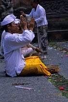 Men praying at a temple in Ubud. Bali, Indonesia.