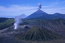Tengger volcano crater + Gunung (Mt.) Semeru (smoking) + Gunung Bromo. Java, Indonesia.
