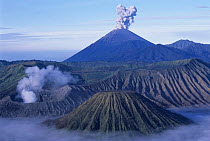 Tengger volcano crater + Gunung (Mt.) Semeru (smoking) + Gunung Bromo. Java, Indonesia.