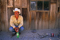 Young man sitting on the side of the street in Batopilas. Chihuahua, Mexico.