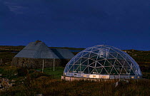 Geodesic greenhouse and restored Black house on the Isle of Uist. Scotland, UK.