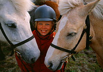 Girl with Icelandic horses, Vindelfjallen nature reserve, Lapland, Sweden.