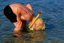 Child, Olle Collinder, watching marine life through snorkel, Bohuslan, Sweden. Model released.
