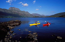 Two sea kayakers on Loch Maree, Beinn Eighe National Nature Reserve, Scotland, UK.