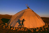 Chukchi girl playing beside her family's Yaranga tent, Chukotka, Russia