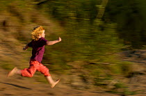Child running on the beach, Varmland, Sweden.
