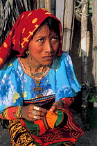 Local woman sewing mola arm decorations, San Blas Islands, Panama