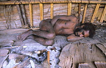 Korowai man sleeping in his house, Western Papuasia, Indonesia. 1999 / 2000. (West Papua).